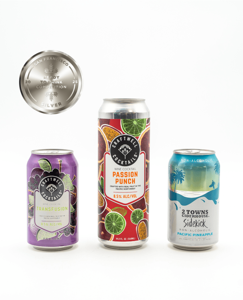 Craftwell cocktails Transfusion and Passion Punch on a white background with 2 Towns Ciderhouse Sidekick Pacific Pineapple. A silver medal is in the top left corner