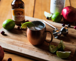 Cosmic Mule cocktail served in a copper mug with lime.