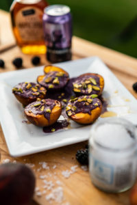 Photo of Grilled peaches filled with vegan blackberry cream surrounded by ingreidents.